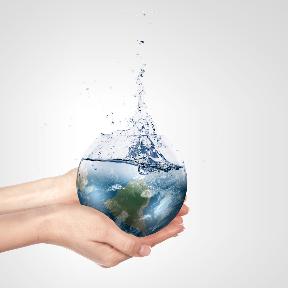 Globe in human hand against blue sky. Environmental protection concept. Elements of this image furnished by NASA